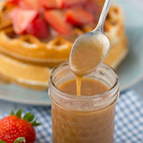 a spoon is being used to stir waffles with peanut butter and strawberries