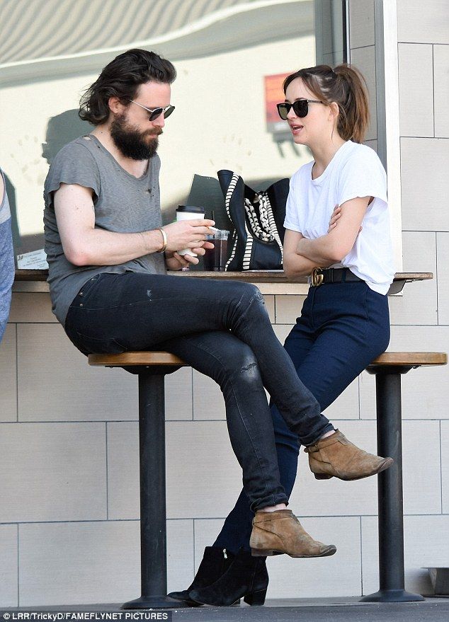 two people sitting at a table drinking coffee