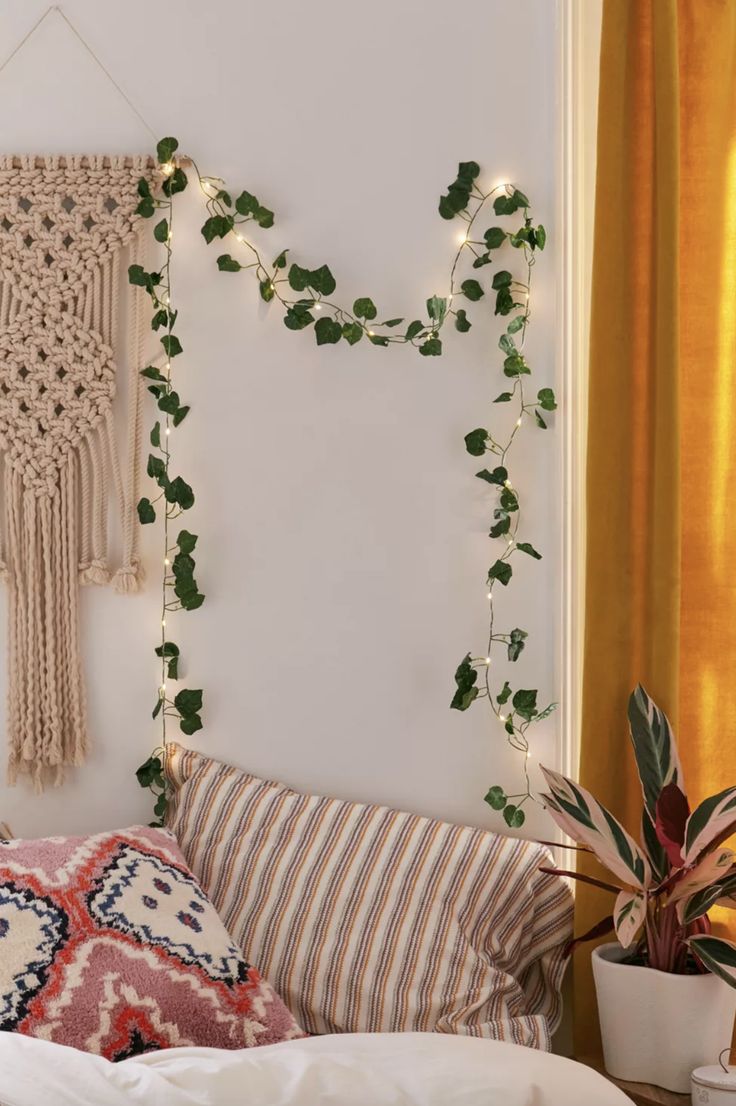 there is a bed with pillows and plants on the headboard, along with other decorations