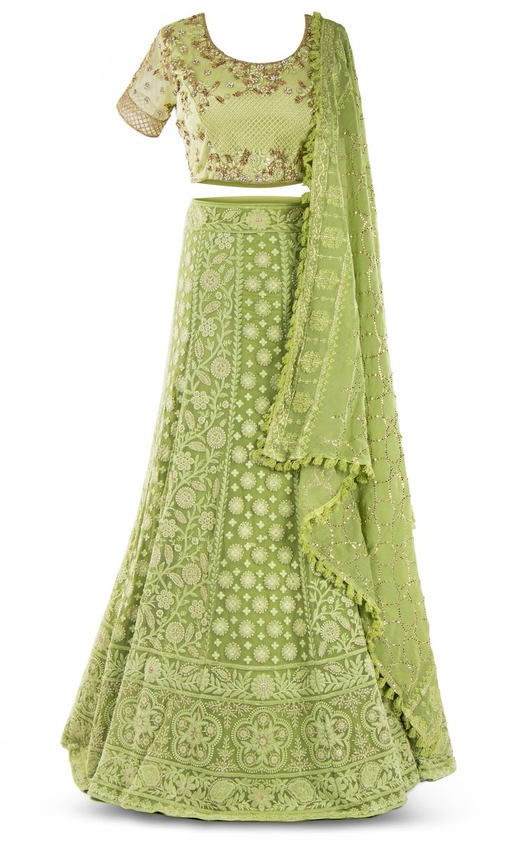 Lime green lehenga paired with a matching skirt with a gorgeous floral pattern garnished in crystals. Designer Green Choli With Intricate Embroidery, Embellished Green Dress For Navratri, Green Bollywood Embellished Lehenga, Green Bollywood Style Embellished Lehenga, Designer Embellished Green Lehenga, Bollywood Style Green Embellished Lehenga, Green Bollywood Lehenga Embellished, Hand Embellished Green Dupatta For Wedding, Green Hand-embellished Wedding Dupatta