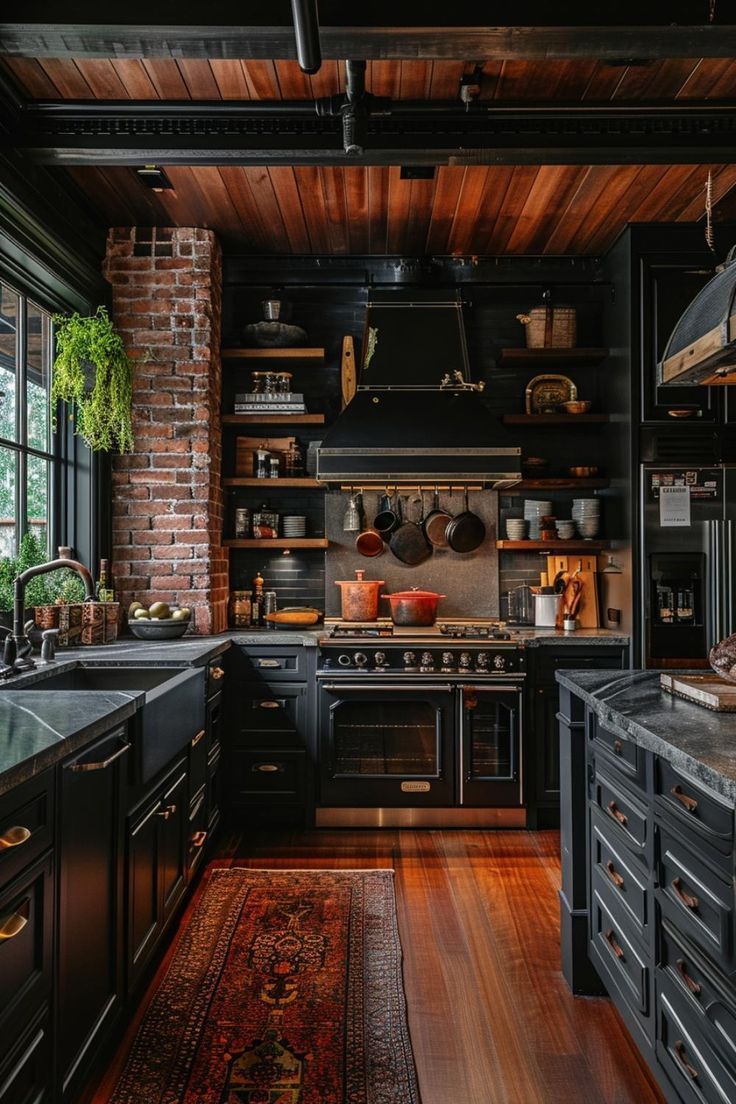 a kitchen with black cabinets and wooden floors, an area rug in front of the stove