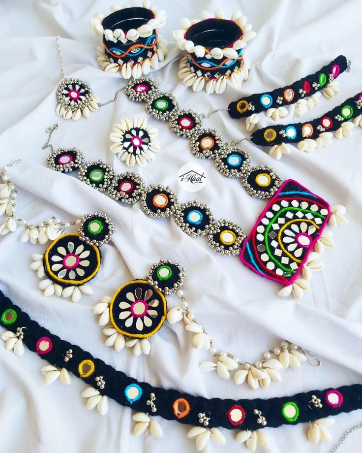 Are you an early bird who's planning to rock this navratri season with her pre-planned traditional look? If yes, checkout this beautiful Multicolored Jewellery Set with black base to match your Garba Vibes for this Navratri Season 🔥 This beautiful ethnic jewellery set is adorned with lots of Cowrie shells and mirrors to give it a traditional Indian look😍 Items included: ❤️ Necklace ❤️ Jhumka with Sahara ❤️ Mang teeka ❤️ 6 Bangles Set ❤️ Ring ❤️ Anklets ❤️ Waist belt This set can b... Navratri Jwellery Set, Navratri Set Design, Navratri Special Jewellery, Garba Jewellery Diy, Diy Navratri Jewellery, Gujrati Jewellery, Handmade Navratri Jewellery, Garba Accessories, Garba Jwellery