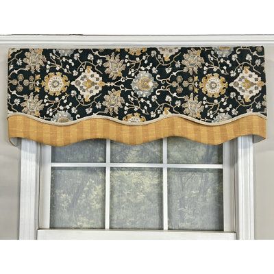 a window with a black and gold valance