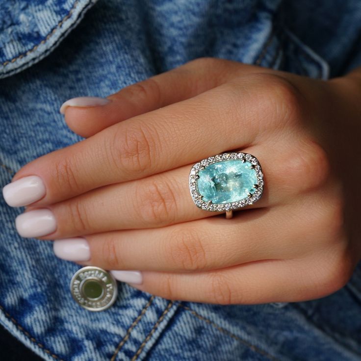 A Breathtakingly Striking HANDMADE 14k White Gold Ring with Beautiful Cushion Cut Paraiba Tourmaline in Green-Blue color! The GEM is 16.03 CT and measures 17.89x12.56x9.18 mm! This Stone will take your breath away, especially on the sunlight! You will want to look at this stone endlessly. The mounting is a masterpiece! HANDMADE 14K White Gold Diamond Mounting (tested), that was is custom made to Accommodate this Beauty of a Gem in a V-prongs setting! Super FINE Workmanship on the Diamond v-split setting with 26 pcs Brilliant Full Cut Diamonds in GH color, SI clarity, totaling to approx  0.97ct! Fabulous Braided Band and Diamond Gallery! The Entire Top's outline is 22.9x17.6mm- HUGE. The Ring weights 12.5 g, nice and SOLID. Sits 12.4 mm off the top of the finger. Finger size 8 (Free Re-sizi Gia Certified Dazzling Gemstones For Gift, Fine Aquamarine Jewelry With Halo Setting, Fine Jewelry Aquamarine With Halo Setting, Fine Jewelry Aquamarine Halo Setting, Fine Jewelry With Aquamarine In Halo Setting, Fine Jewelry With Aquamarine Halo Setting, Cushion Cut Aquamarine Gemstone Jewelry, Gia Certified Aquamarine Jewelry Ring, Gia Certified Aquamarine Jewelry For Formal Occasions