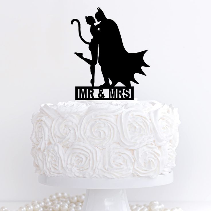 a cake topper that says mr and mrs with a silhouette of batman and cat