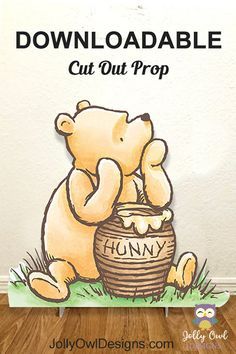 a teddy bear sitting on top of a basket next to a sign that says, downloadable cut out prop