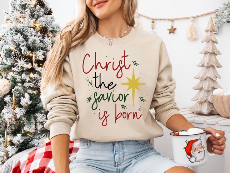 Christ the Savior Sweatshirt, Christian Christmas Shirt, Religious Holiday Sweater, Faith-Based Christmas Crewneck, Inspirational Gift The classic fit along with the crew neckline deliver a comfy wearing experience with a clean-cut style. Meanwhile, the double-needle stitching at the shoulder, armhole, neck, waistband, and cuff seams add top-tier durability. ❤️❤️❤️❤️❤️❤️ Experience pure comfort with this timeless unisex heavy blend crewneck sweatshirt. Crafted from a blend of polyester and cotto Jesus Nativity, Scene Shirt, Christmas Words, Fabric Combinations, Holiday Sweatshirt, Christian Christmas, Christmas Vibes, Sweater Gift, Holiday Sweater