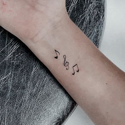 a person's arm with musical notes on it