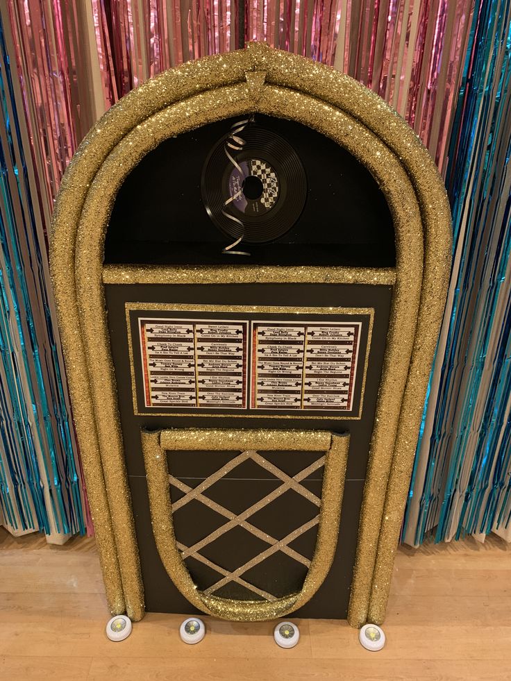 an old fashioned jukebox with gold glitter on it