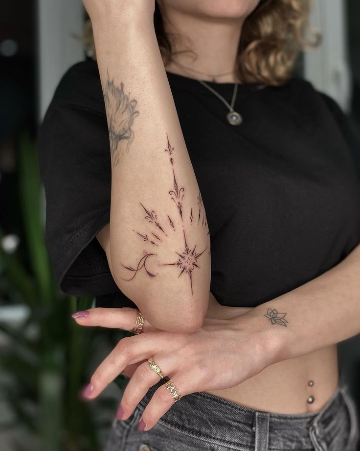 a woman with tattoos on her arm and hand