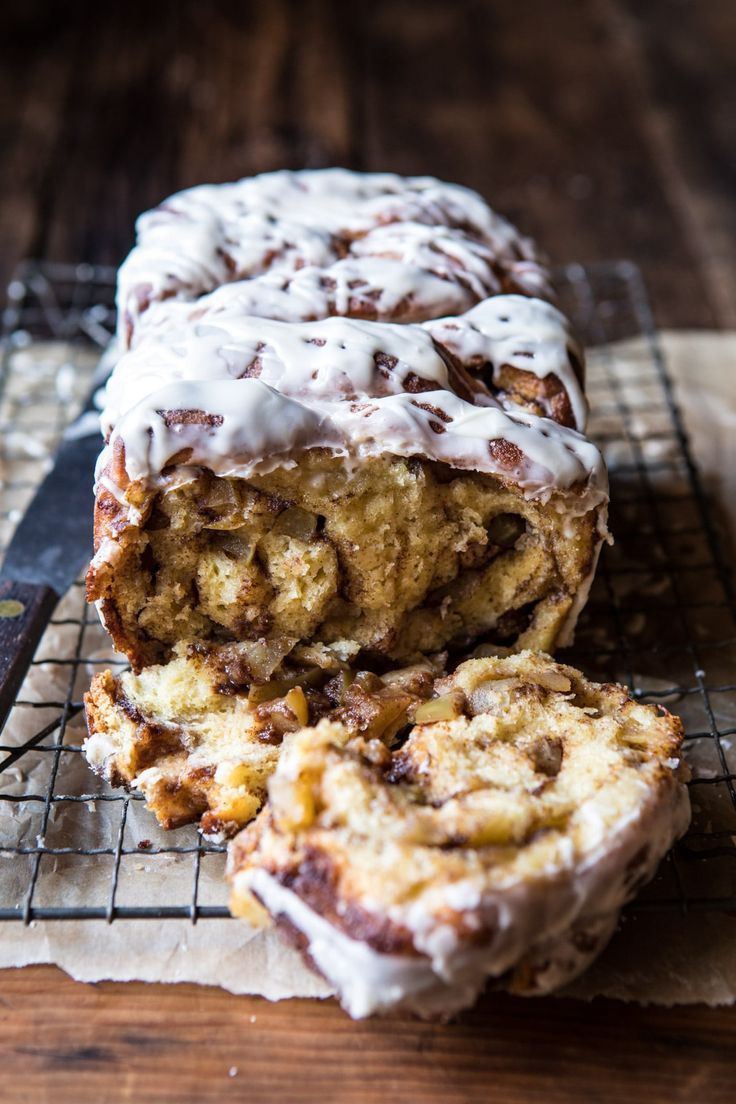 a loaf of cinnamon bread with icing on a cooling rack