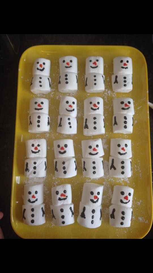 snowmen made out of marshmallows sitting on top of an ice tray