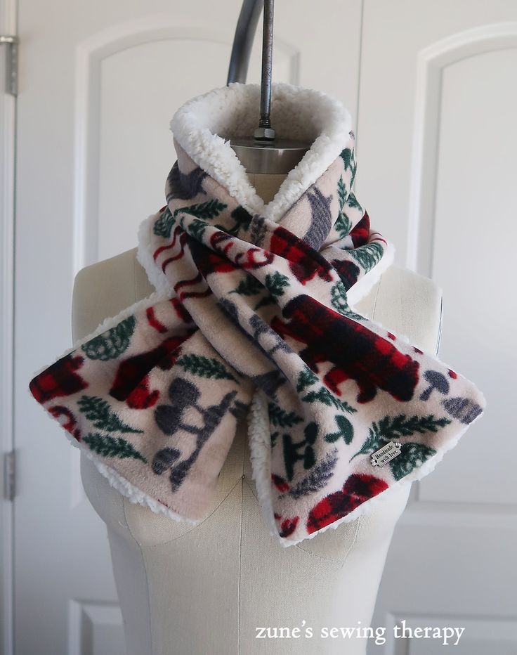 a white mannequin with a red and green scarf on it's neck