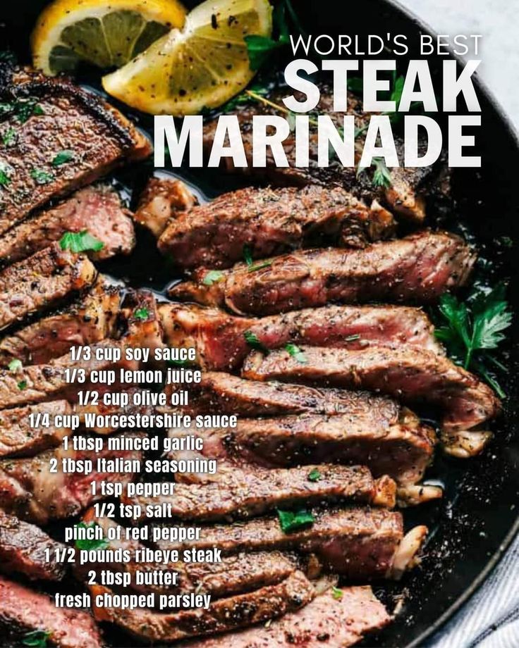 steak marinade in a skillet with lemon wedges and parsley