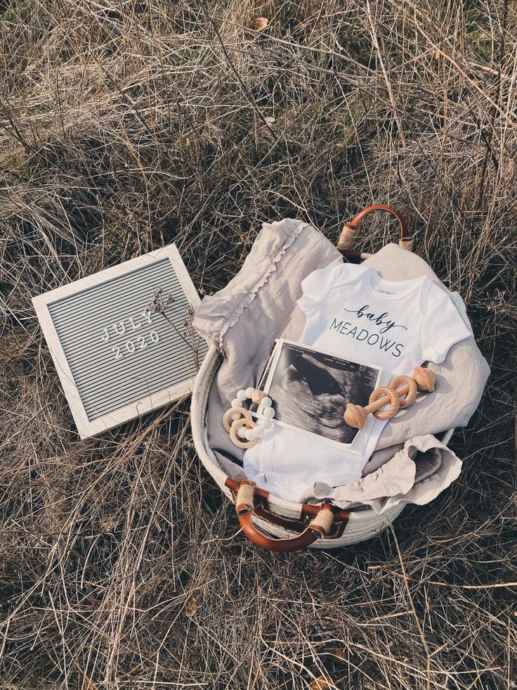 an open suitcase with clothes and other items in it on the ground next to a sign