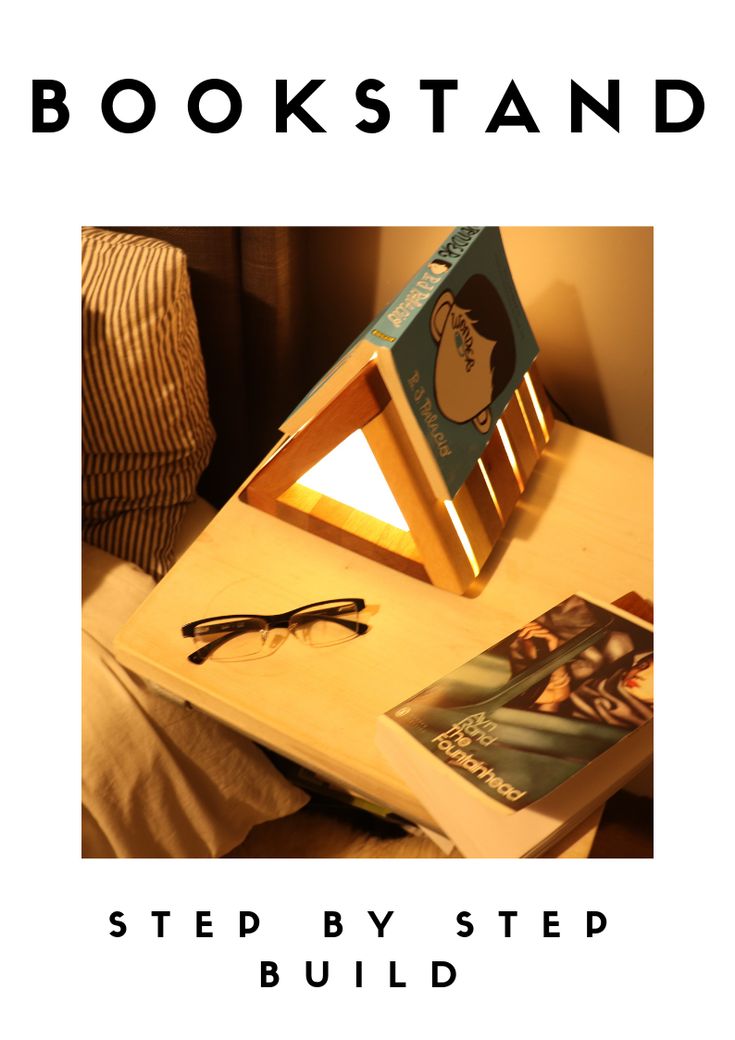 an open book sitting on top of a wooden table next to a pair of glasses