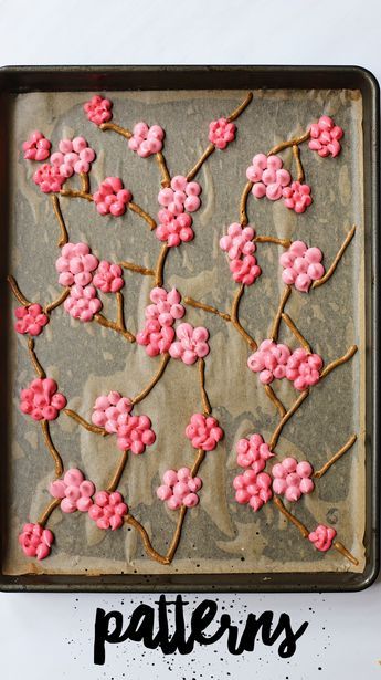 a baking sheet with pink flowers on it and the words patterns written in black ink