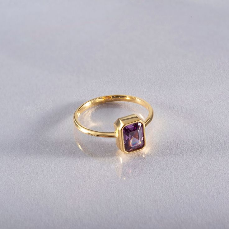 This elegant 14K solid gold ring features a stunning rectangular amethyst, making it a perfect piece of birthstone jewelry. The rich purple hue of the amethyst, which is the birthstone for February, symbolizes clarity, calmness, and spiritual growth. Whether you're celebrating a birthday, anniversary, or any special occasion, this ring makes a thoughtful and unique gift. Its timeless design ensures it will be cherished for years to come. As a Christmas gift, it offers both beauty and personal significance, with the luxurious combination of gold and amethyst creating an elegant look. The deep, vibrant color of the amethyst is beautifully complemented by the warm glow of the solid gold band, making this ring a standout piece in any jewelry collection. Suitable for both everyday wear and spec Formal Birthstone Ring With Rectangular Stone, Gift Yellow Gold Radiant Cut Sapphire Ring, Gold Sapphire Ring With Radiant Cut For Gift, Rectangular Amethyst Ring In Yellow Gold, Gold Radiant Cut Sapphire Ring Gift, 14k Yellow Gold Emerald-cut Amethyst Ring, Yellow Gold Amethyst Ring With Rectangular Shape, Classic Yellow Gold Rectangular Amethyst Ring, Yellow Gold Amethyst Ring With Emerald Cut