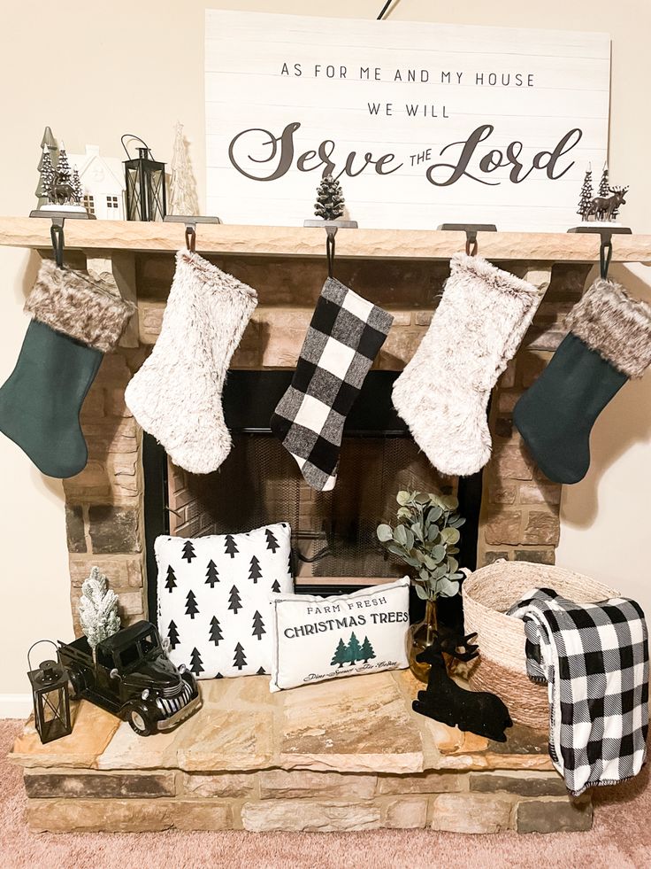 stockings hung on the mantle above a fireplace decorated with christmas stocking and other holiday decorations