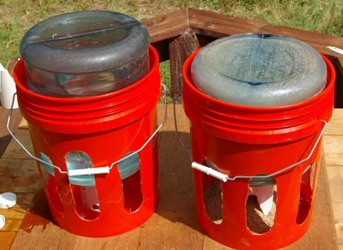 two red containers sitting on top of a wooden table