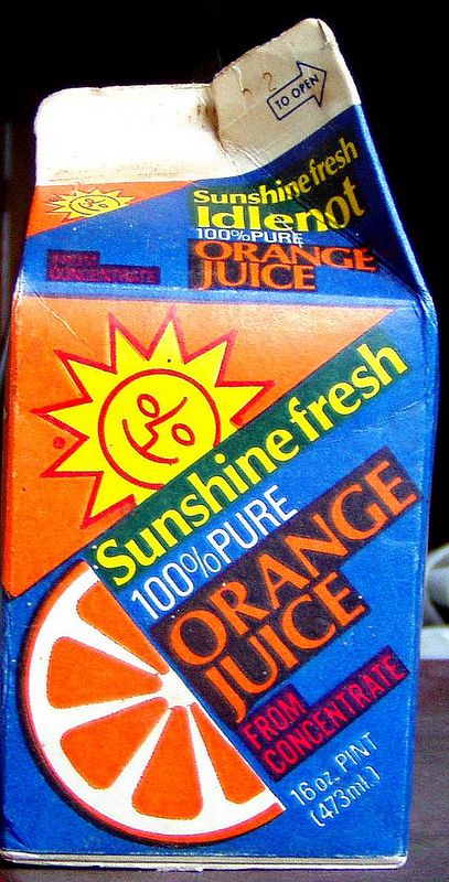 an orange juice carton sitting on top of a table