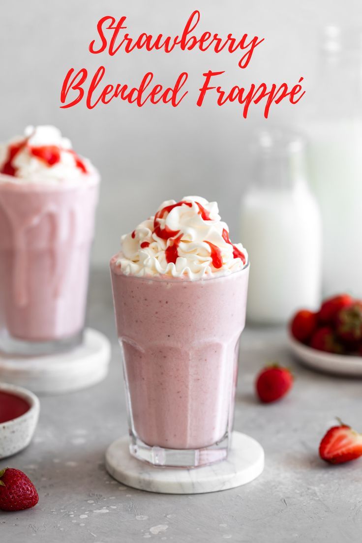 two glasses filled with strawberries and whipped cream on top of each other next to milk