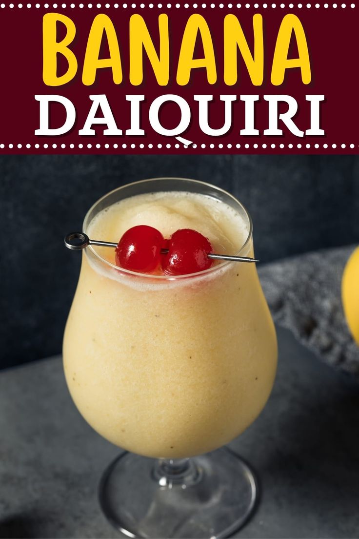 a banana daiquite is garnished with two cherries