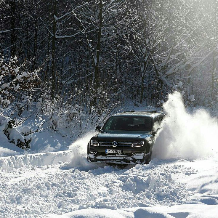 a car driving through the snow on a road