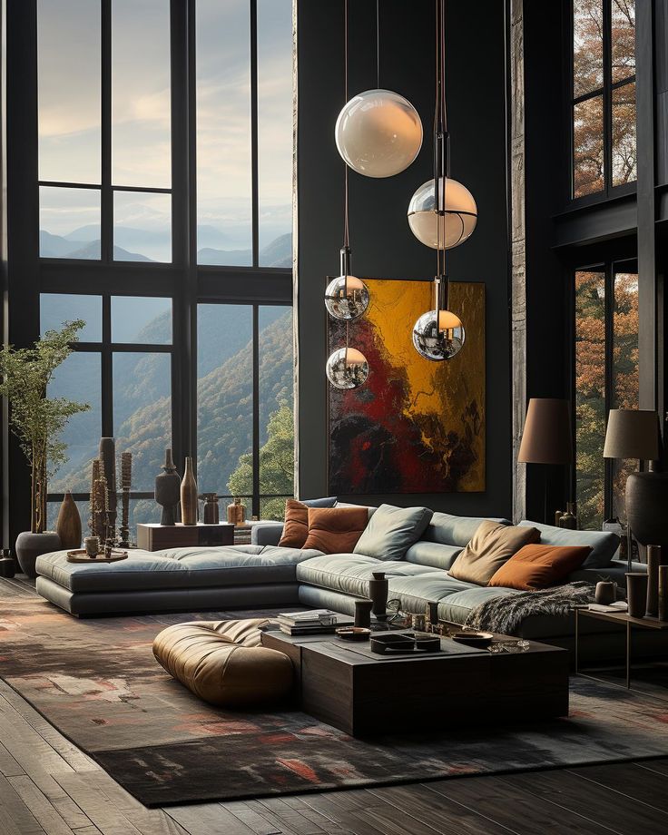 a living room filled with lots of furniture and large windows overlooking the mountain range in the distance