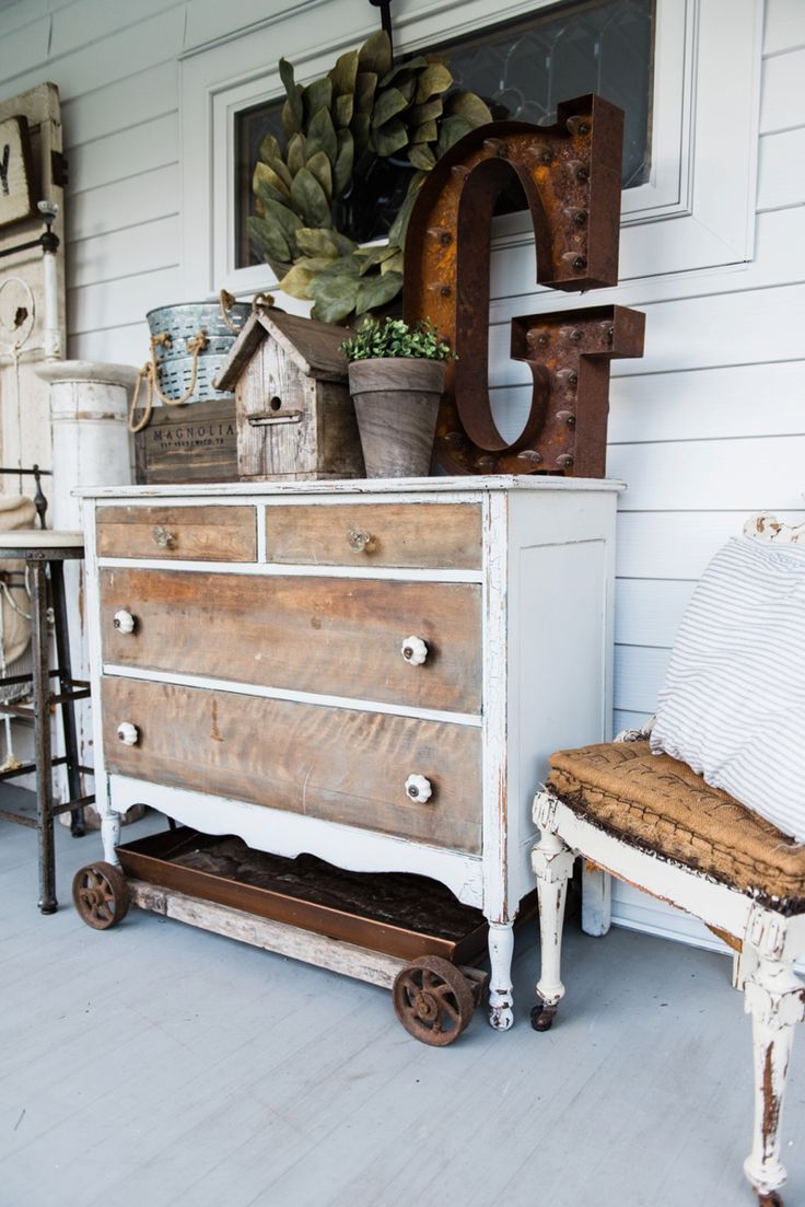 an old dresser with some plants on top