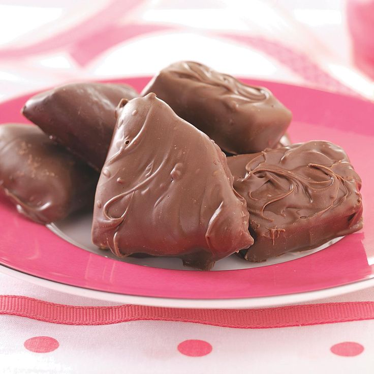 three pieces of chocolate on a pink plate