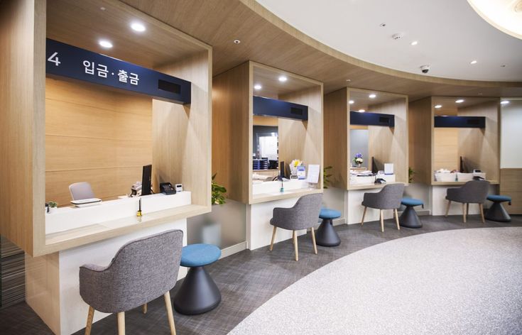 the interior of an office with chairs and desks on each side of the room