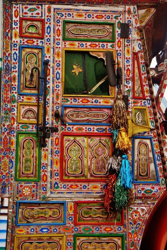 colorfully painted wooden door with decorative decorations on it