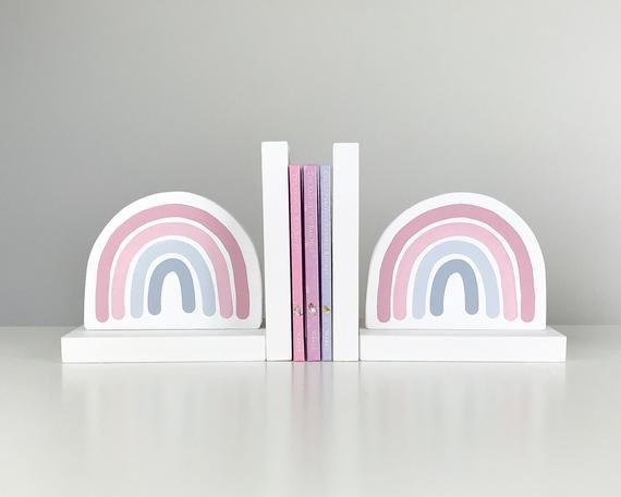 two bookends with pink, blue and white designs on them