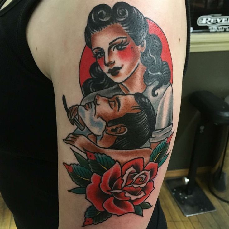 a woman's arm with an old school tattoo design on it and a rose