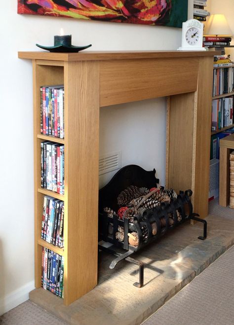 a fireplace with bookshelves and a painting on the wall