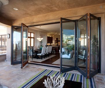 an open living room and dining area with glass doors