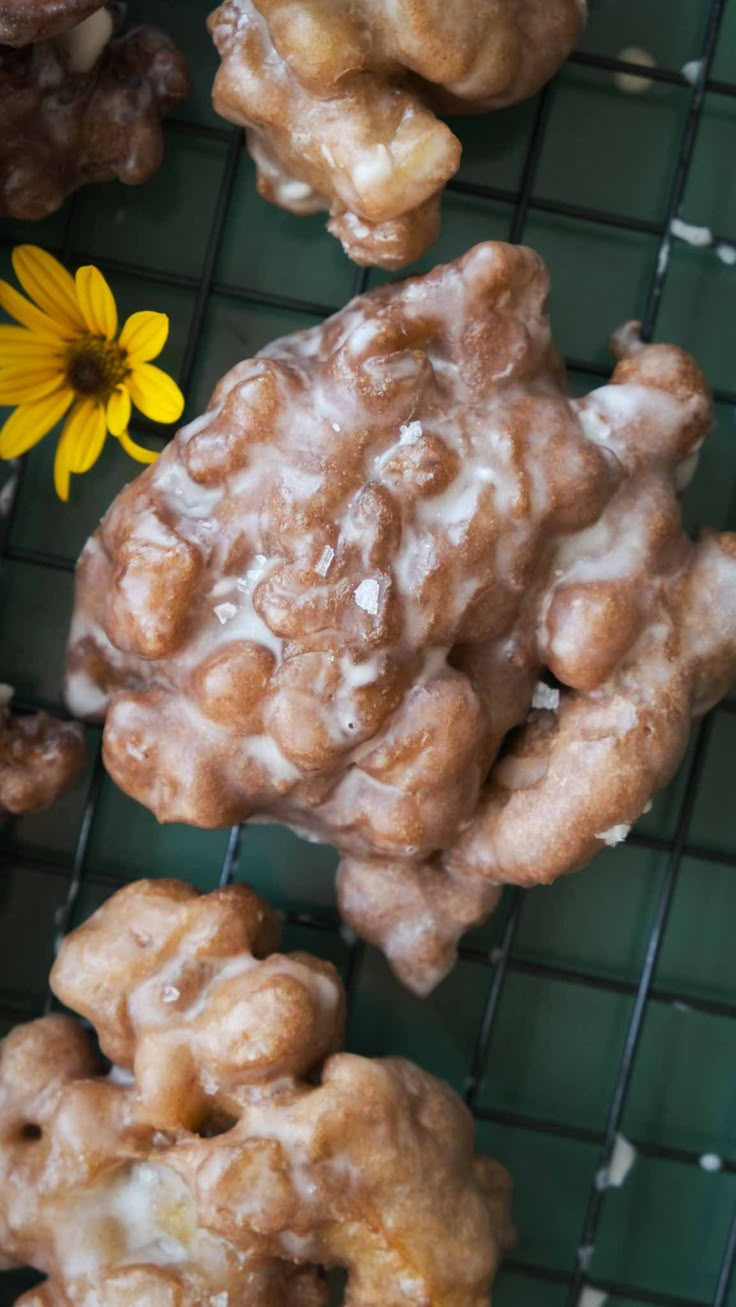 there are some donuts and a flower on the cooling rack