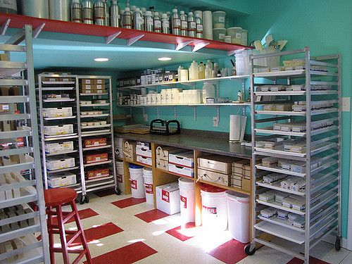 the inside of a storage room with shelves and bins