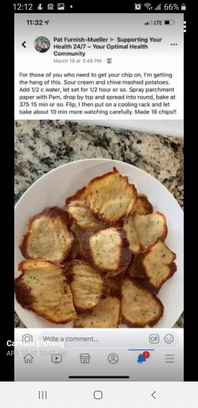 a white plate topped with sliced potatoes on top of a counter next to a cell phone