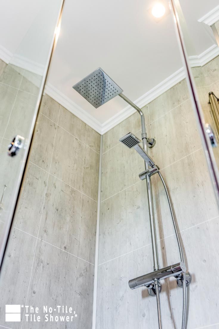 a shower head and hand shower in a bathroom