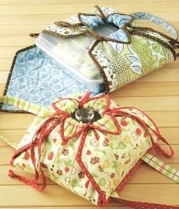 three bags with ties tied around them sitting on a wooden floor next to each other