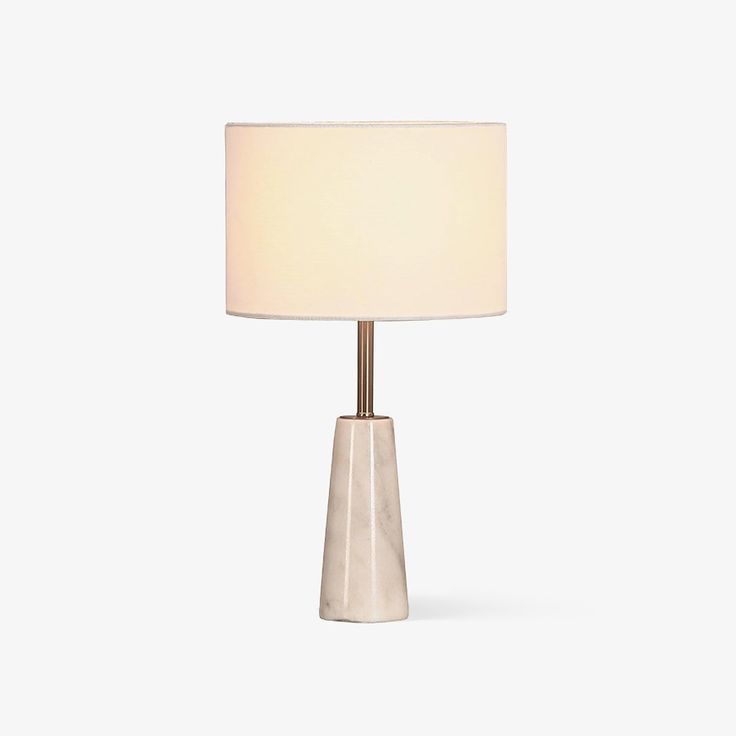 a table lamp with a white shade on it