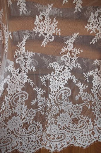 white lace on brown fabric with flowers