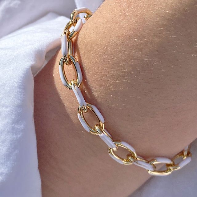 do you have summer on your mind? the days of golden hour by the water and sun-kissed skin are here. our Summer On My Mind bracelet features a unique, two-tone design. its half-gold, half-enamel finish adds dimension, allowing you to accessorize your looks for any occasion. if you're really craving that sophisticated summer look, pair it with any of our pearl pieces to add more dimension and interest to any ensemble. materials: 18k triple gold plated brass, enamel measurements: 8 mm thick. can be Trendy White Enamel Jewelry, Trendy Gold Chain Bracelet For Summer, Trendy White Bangle Chain Bracelet, White Adjustable Chain Bracelet, White Enamel Bracelet Jewelry, Trendy Metal Bracelets For Beach, Trendy White Metal Bracelets, White Bangle For Vacation, White Bangle Jewelry For Vacation