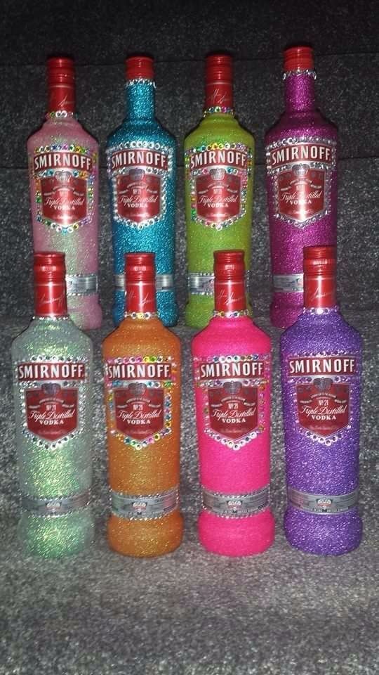 six bottles of smiroff vodka are lined up in a row on the floor