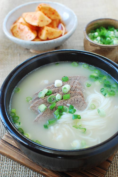 a bowl of soup with meat and green onions