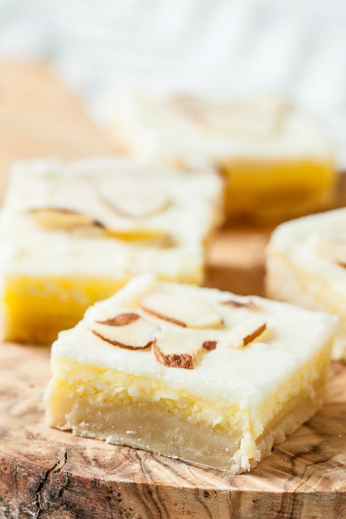 pieces of cake sitting on top of a wooden cutting board