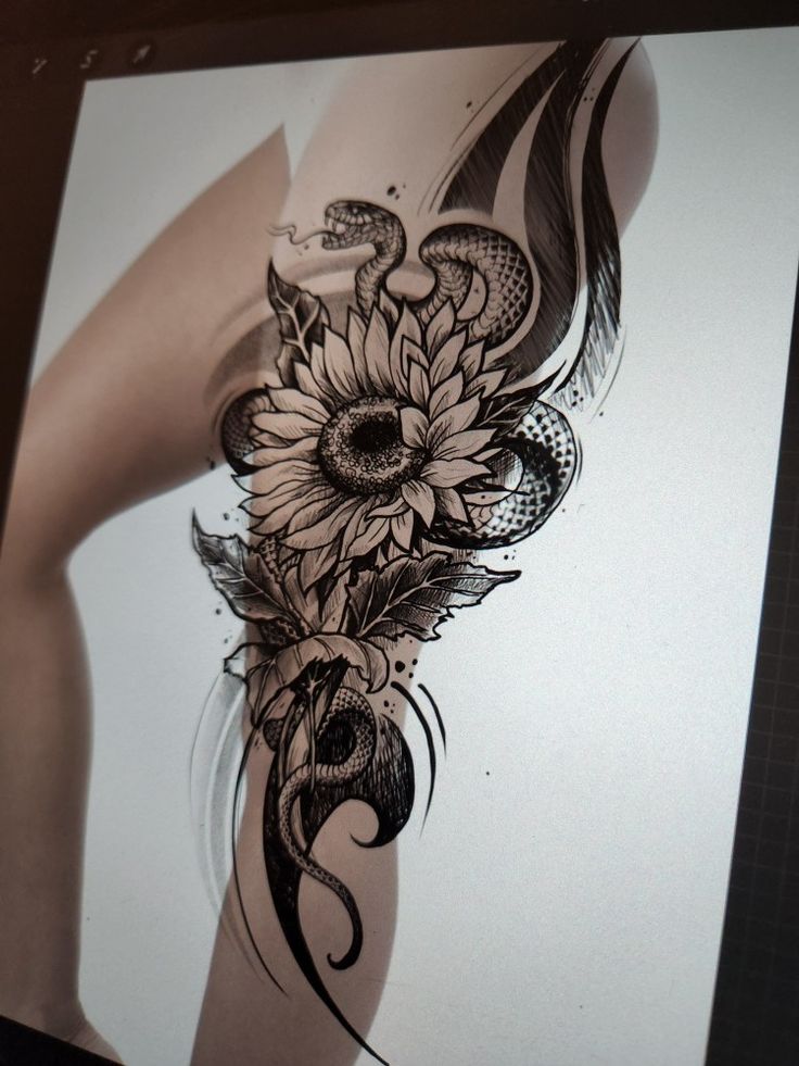 a woman's thigh with sunflowers and snake tattoo design on the side