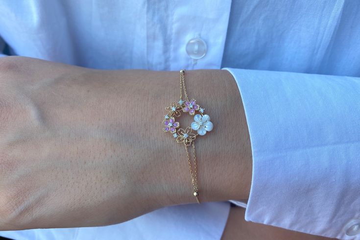 "Flower Bracelet, Unique Diamond and Sapphire Flower Bracelet, 14k Gold Diamond Bracelet, Solid Gold Dainty Diamond Bracelet, Gifts For Her A real present for yourself or someone else! This lovely 14k solid gold necklace with 1 dainty flower, 10 sapphire stones and 9 diamonds. Bracelet length: 7inches.(can be personalized as your wish). Chain width: 0.85MM. Material: 14K solid yellow -, white-, or rosegold. Diamonds: 0.09 ct. White Diamond G Color SI-VS Clarity. Sapphires: 0.16 ct. Pink Sapphire Delicate Floral Bracelet For Formal Occasions, Dainty White Gold Flower Bracelet, Delicate Yellow Gold Flower Bracelet, Dainty Yellow Gold Bracelet With Flower Charm, Delicate White 14k Gold Bracelet, Suede Box, Diamonds Bracelet, Gold Diamond Bracelet, Sapphire Stones